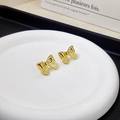 Elegant gold bow earrings for women featuring minimalist three-dimensional metal design - Gold Bow Stud Earrings Pair / Gold