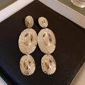 Macro view of silver tassel earrings featuring irregular hammered metal oval pendants - Style 28# S925 Silver Pin Silver Triple Oval Drops