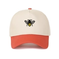 Detailed close-up of a bee embroidery on a color-block cotton five-panel trucker hat - Orange Red