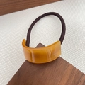 Brown elastic hair tie with amber acetate geometric piece and gold lettering detail - Yellow