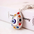 Porte-clés Evil Eye argenté avec strass colorés sur fond de livre pour femmes - Argenté