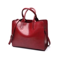 Detail view of red PU leather tote bag with sturdy handles and adjustable shoulder strap - Burgundy