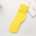 Bright yellow ribbed mid-calf slouch socks laid flat on a clean white background - One Size / Bright Yellow
