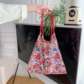 Close-up of floral tote bag handles with detailed fabric texture and patterns - Colorful Floral