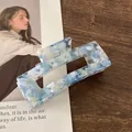 Blue marble acetic acid rectangle hair claw clip with rhinestones on a wooden surface - 10cm / Sky Blue