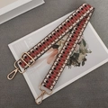 Detail of red and black geometric woven purse strap with gold metal swivel snap hooks - Red White Coffee + Gold Hook