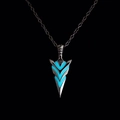 Macro detail of arrow pendant with glowing blue stripes and vintage metal finish - Light Blue Glow