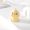 Macro shot of a yellow flocked chick pendant with metal loop for DIY jewelry design - Yellow Duck