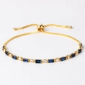 Detail of gold snake chain bracelet with dark blue rectangular and clear round stones - Royal Blue Zircon Gold