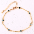 Detail of gold-plated anklet featuring blue evil eye beads and lobster clasp closure - Light Blue Bracelet