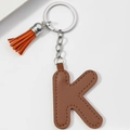 Detail of a brown leather letter K keychain with decorative tassel and silver metal ring - Brown-Letter K