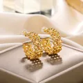 Macro shot of gold-plated C-shaped earrings with intricate woven mesh texture on velvet - Gold Hollow Woven C-Shaped Earrings (E3418G)