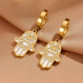 Detail of golden Hamsa Hand earrings with white shell inlay on champagne satin background - Pendant Hoop Earrings (G212)