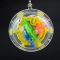 Close-up of 3D maze ball puzzle keychain with colorful internal tracks and metal bead chain - Small Round UFO Maze