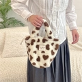 Detail of plush handbag with heart pattern featuring brand tag and fuzzy texture - White Hearts