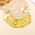 Close-up of golden multi-layer scale chain bracelet with heart charm and lobster clasp - 3-Row Coin Bracelet