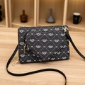 Black crossbody camera bag with white diamond print and heart-shaped coin purse attachment - Black