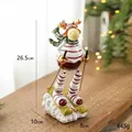 Resin Christmas reindeer figurine in skiing pose with red outfit on snow base - Skiing Reindeer Ornament