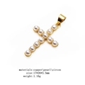 Detailed macro view of gold cross pendant with micro-set pearls and cubic zirconia - Cross