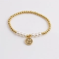 Gold plated beaded bracelet with white pearls and a sparkling zircon smiley face charm - Pave Zirconia Smile / Gold