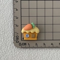 Resin carrot house accessory for DIY crafts and shoe charms on a grid mat - House
