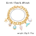 Detail shot of golden ocean charms with starfish shell and pearls on a dainty chain - Bracelet / Gold