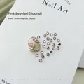 Macro shot of 50pcs 3mm pink round zircon nail art rhinestones on textured white paper - Pink Round 3x3 (XY-1011)