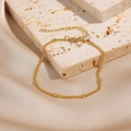 Elegant gold twisted chain bracelet featuring polished metal beads and lobster clasp - Gold Twisted Rope Bead Chain (0070-9)