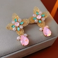Detail of vintage gold flower earrings with pink and blue rhinestones on a velvet display - Silver Needle (Silver Needle-Pink) / Pink
