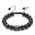 Detail of adjustable black agate bead bracelet featuring a gold letter U on black bead - Letter U