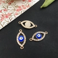 Close-up of golden evil eye charm connectors with blue enamel and sparkling rhinestones - KC Gold - Evil Eye Connector - 21x10mm