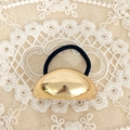 Macro detail of glossy gold metal ball ornament on elastic black hair tie for women - Gold Large Oval