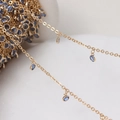 Detailed view of gold plated chain with small blue round zircon pendants for DIY jewelry - Gold Chain - Light Blue Stone