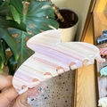 Close-up of a pink and white marble acetate hair claw clip with wavy edges and glossy finish - Large / Cream Stripes