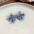 Elegant ice blue ceramic flower earrings with crystals and golden finish details - Iridescent Flower / Light Blue