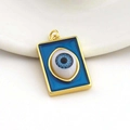 Macro view of a rectangular gold-plated evil eye pendant with blue enamel and eye detail - 12-Rectangular Blue Enamel Eye
