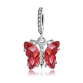 Macro shot of silver butterfly charm with faceted red crystals and clear stone inlay - Red