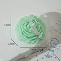 Light green peony flower scented candle with white label on textured stone display - Mint Green