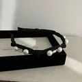 Detail of black fabric headband with pearls and square crystals on a velvet box - Knot Headband / Pearl Style - Black