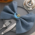 Detailed view of gold moon napkin ring with blue oil-drop design on a dining table - Enamel Smiley Face Moon Star