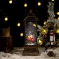 Bronze Christmas lantern with Santa sleigh scene and swirling glitter snow effect - Santa Claus