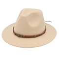 Macro detail of beige wool fedora hat featuring brown leather band and skull emblem - Beige