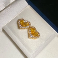Detalle de pendientes de botón de corazón dorado con circonitas en un joyero de terciopelo - Pendientes de Botón de Corazón de Circonita Amarilla (Aguja de Plata Color Dorado)