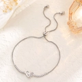 Detail of adjustable silver tennis bracelet with heart charms and sparkling crystals - Double Heart Clasp Style / Silver