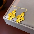 Detailed macro shot of 18K gold plated flower tassel earrings on a luxury display box - Ear Hook - Gold