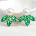 Macro shot of gold earrings with large white pearl and green marquise crystals - Green