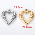 Macro view of gold and silver heart angel wing pendants with size 21.8mm x 20.8mm - Heart