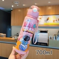 Close-up of pink 700ml astronaut water bottle with straw and portable handle strap - 700ml / Pink