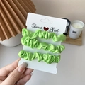 Three-piece set of vibrant light green satin hair scrunchies on display card - 3 Piece Set / Light Green