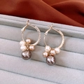 Close-up of golden pearl hoop earrings with zircon stones in a gray velvet jewelry box - Gold Metal Multi-Pearl Large Earrings
